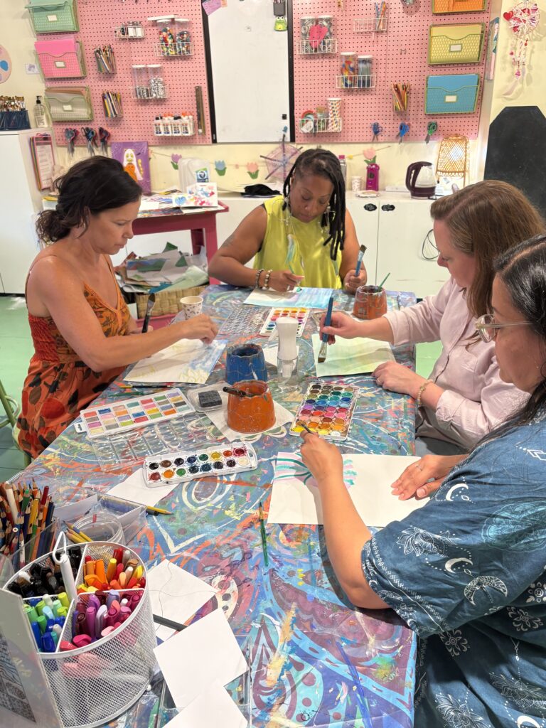 Adults creating relaxing mixed-media art projects during The Art of De-Stressing workshop at Pink Art Pixie in Joppa, Maryland. Adults painting and crafting together during The Art of De-Stressing, a relaxing creative workshop at Pink Art Pixie in Joppa, MD.
