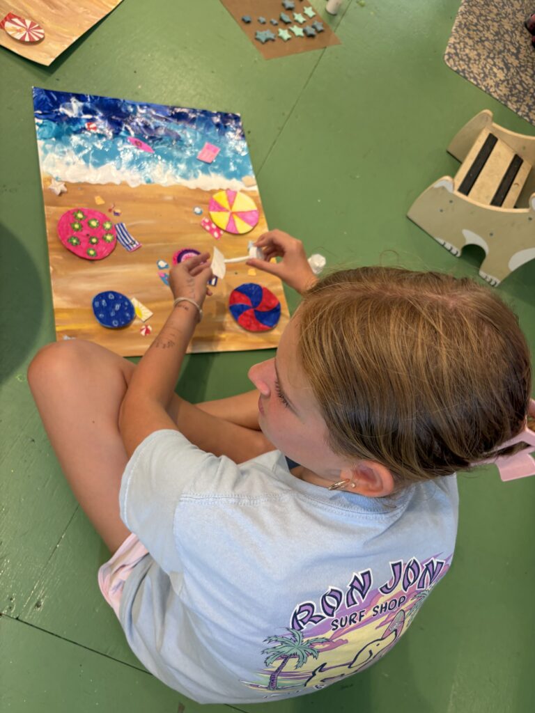 Child creating a colorful mixed-media canvas during kids art camp at Pink Art Pixie in Joppa, Maryland